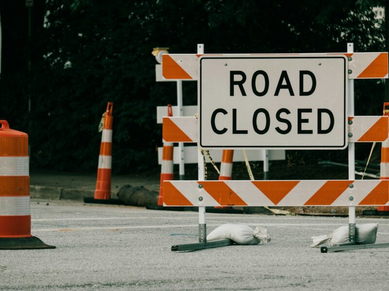 a road sign with orange cones