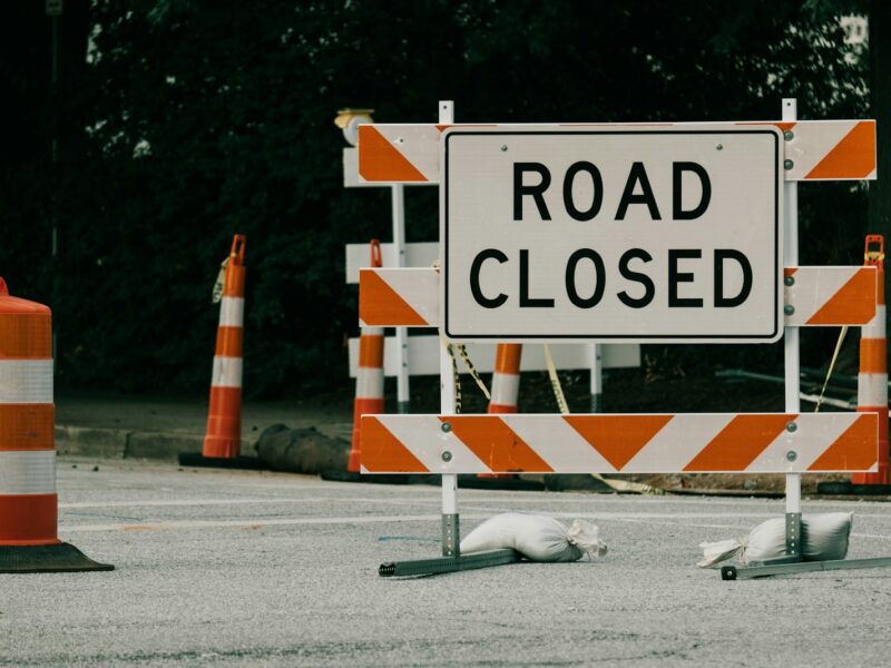 a road sign with orange cones