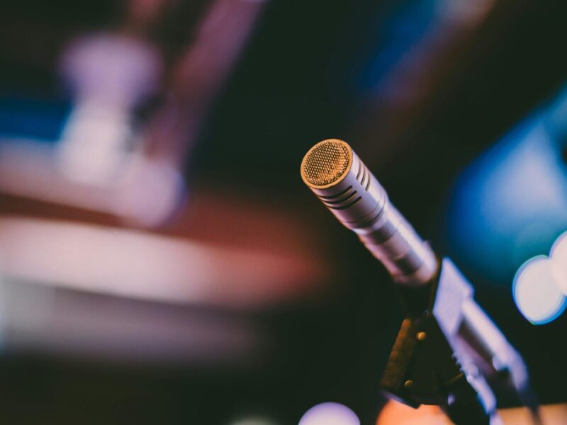 Detailed shot of a microphone with artistic bokeh background, ideal for concerts.