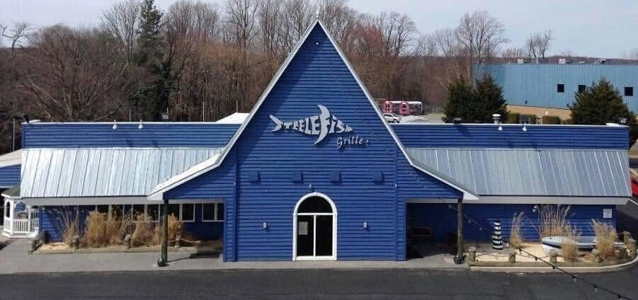 Blue SteelFish grille building with a steep front gable and silver metal roof