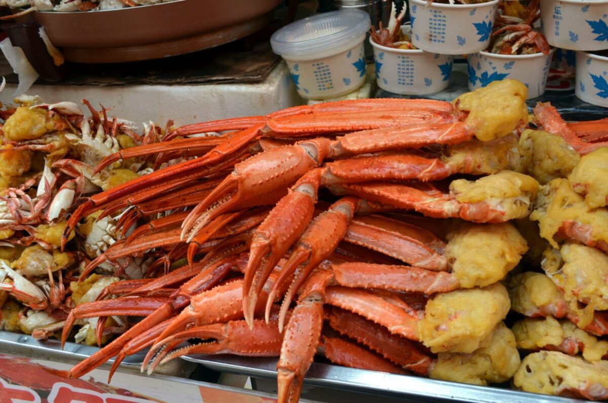 Delicious freshly cooked crab legs displayed at a vibrant street food market, perfect for seafood lovers.
